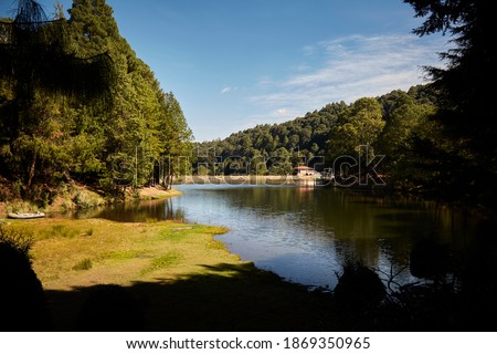Panoramic view of the artificial lake and ecological park El llano dam in Mexico State, Mexico, under a beautiful blue sky on a sunny morning. Forest background.