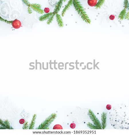Christmas card white background with stars baubles fir tree branches and red berries border frame with copy space
