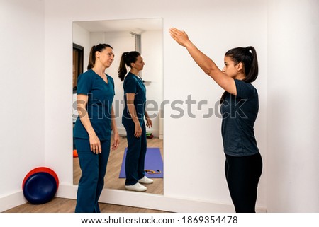 Stock photo of a woman doing rehabilitation exercises with professional worker.