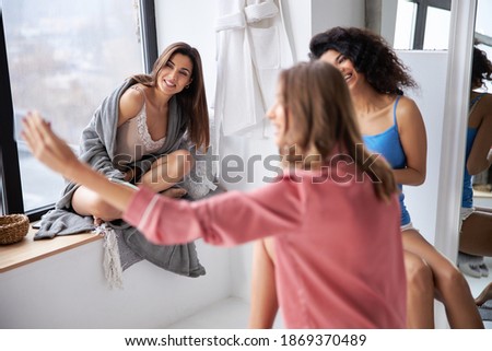 Three lovely best friends making selfie at the bathroom. Stock photo