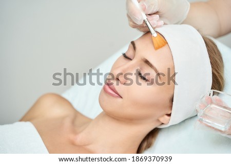 Cosmetology beauty procedure. Young woman skin care. Beautiful female person. Rejuvenation treatment. Facial chemical peel therapy. Clinical healthcare. Doctor hand. Dermatology cleanser. Royalty-Free Stock Photo #1869370939