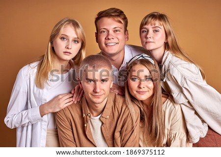 close-up portraot of youth of caucasian appearance ethnicity looking at camera together, wearing beige clothes