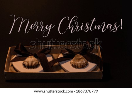Christmas greeting card with two hearts and shells