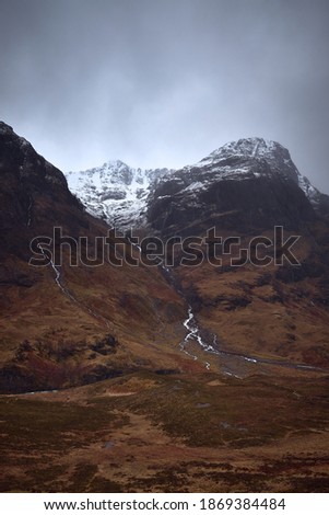 Three Sisters Mountains, Glencoe. Bidean nam Bian in the picture. . Snowy atmosphere in winter, after a big storm. Rain in the environment. Horrible February day in full red alert for weather