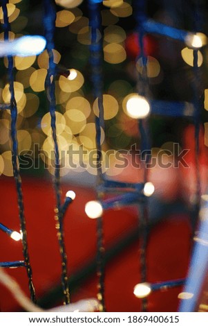 Festive background with LED lights garland. Christmas and New Year background. Blurred bokeh from the lights of a garland.