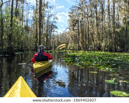 Kayaking couple in Okefenokee swamp in Georgia, USA. Royalty-Free Stock Photo #1869402607