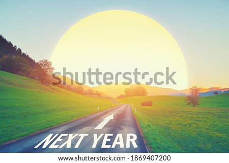 Empty open asphalt road. New year concept. Driving on road against sun sky to upcoming 2022 and leaving behind old years Growth success work, passing life time. Next hope future goals, run path aspire Royalty-Free Stock Photo #1869407200
