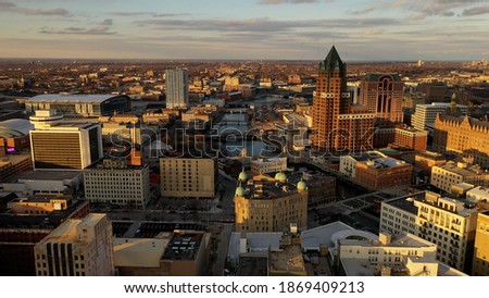 Aerial view of American city at sunset. Modern buildings, skyscrapers. Cloudy sky, cityscape. Milwaukee, Wisconsin