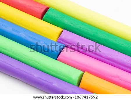 isolated multi colors of clay sticks on white background 