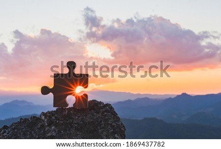 jigsaw puzzle on top mountain sunset background