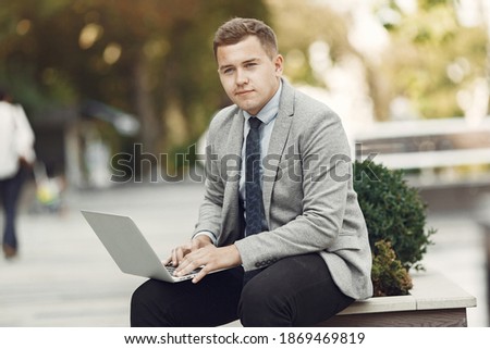Businessman. Guy in a suit. Male use a laptop.