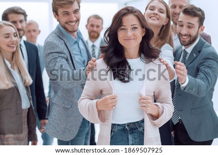 happy business team admiring their young leader Royalty-Free Stock Photo #1869507925