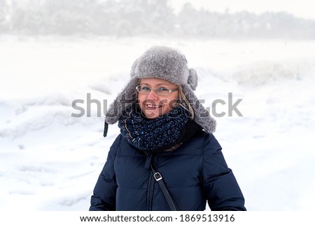 Smiling woman on the background of winter landscape, Jurmala, Latvia. Winter walk.