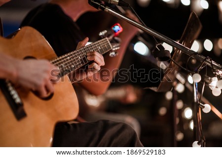 The musician plays and the lead singer sings on stage at the music festival at night.
Concert,mini concert and music festivals. Royalty-Free Stock Photo #1869529183
