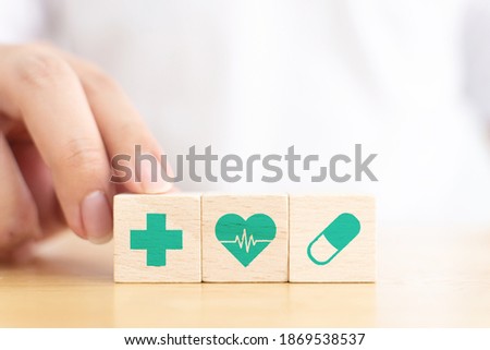 Hand arranging wood block with icon healthcare medical, Insurance for your health concept