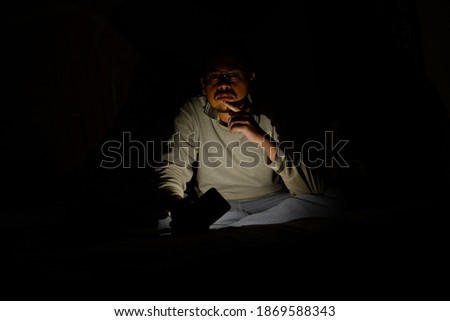 Portrait of a young man in a dark room 