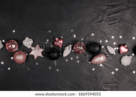 Decorations Christmas border on a black background. Copy space, top view, flat layer.