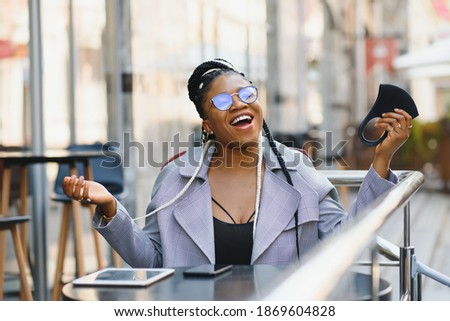 Cute black woman have fun in a city.