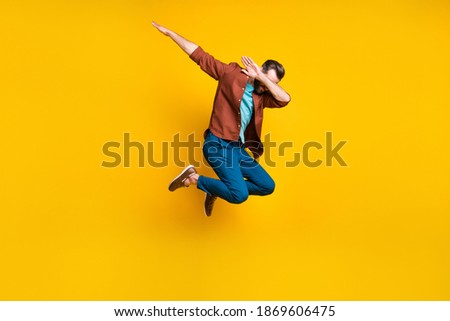 Full length body size photo of male student showing hype dab sign jumping isolated on vivid yellow color background Royalty-Free Stock Photo #1869606475