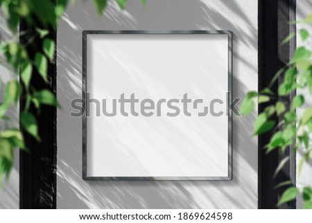 Metal frame hanging in street mockup. Template of a picture framed on a wall bathed in sunlight and shadows 3D rendering