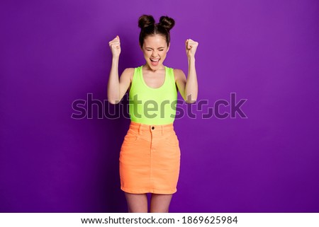 Photo of ecstatic girl raise fists scream lottery win wear tank-top isolated over bright purple color background