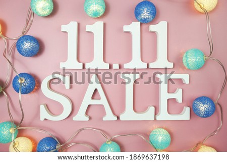 11.11 Sale alphabet letter with LED cotton balls on pink background