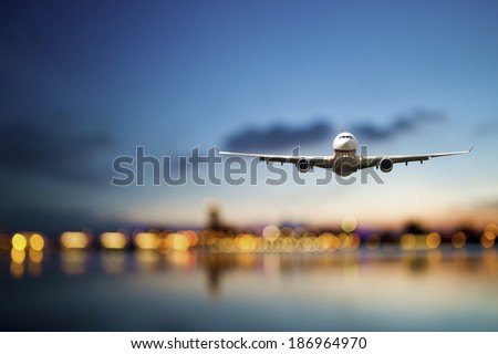 perspective view of jet airliner in flight with bokeh background Royalty-Free Stock Photo #186964970