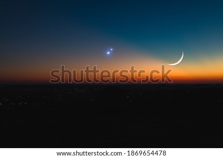Astronomical conjunction of Saturn, Jupiter and Moon. Royalty-Free Stock Photo #1869654478