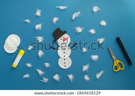 Easy Winter Craft for kid. Winter card Snowman from cotton disc and cotton wool. Children's art project. DIY concept.