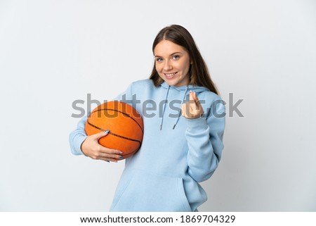Young Lithuanian woman playing basketball isolated on white background making money gesture