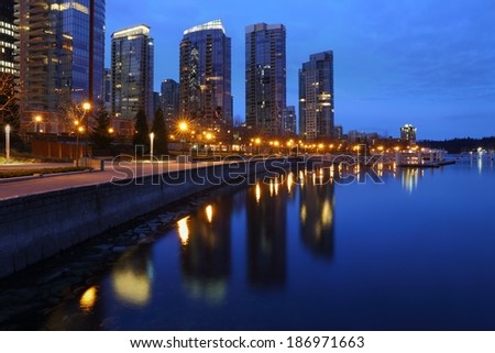Coal Harbor Towers, Twilight, Vancouver. Condominiums at twilight reflect in the calm water of Coal Harbor in downtown Vancouver. British Columbia, Canada. 