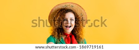 amazed woman in straw hat isolated on yellow, banner