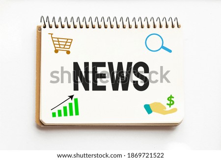 Notepad with text NEWS. White background. Business
