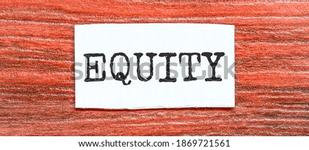 EQUITY text on the piece of paper on the red wood background