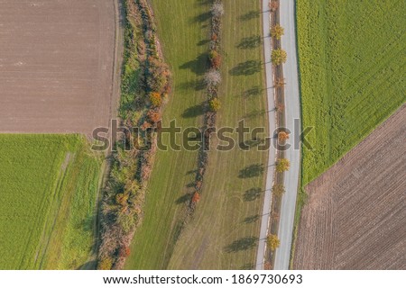 Picture of an aerial view of the landscape in Bavaria with street field path trees bushes field meadow field, Germany