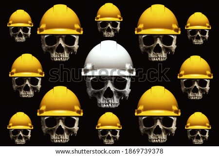 Human skulls wearing safety helmets, isolated on black background. Abstract concept symbolizing death.