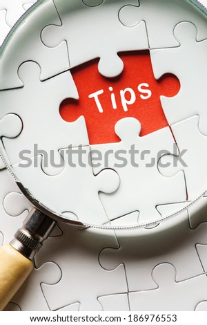 Magnifying glass searching missing puzzle peace "TIPS"