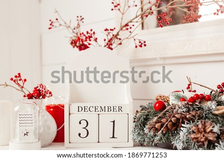 wooden cubes with the inscription December 31 on a christmas background.