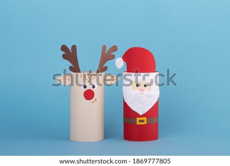 Merry Christmas collection of toys from a roll of toilet paper. Santa and reindeer on a blue background