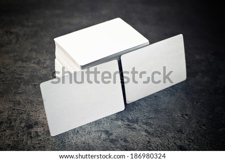 Business cards with rounded corners. Stack of blank horizontal business cards propped up another with copy space for your design.