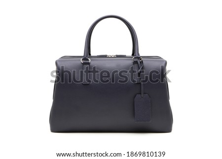 Women's black leather bowling bag, isolated on white. Studio shot.
