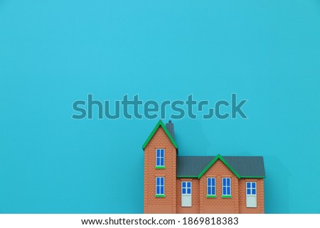 miniature house english design style with blue background isolated 