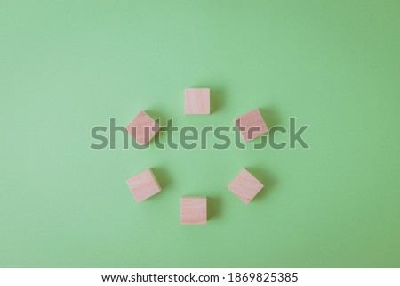 Process Development Concept with Circle Wood Cubes. Green background, copy space
