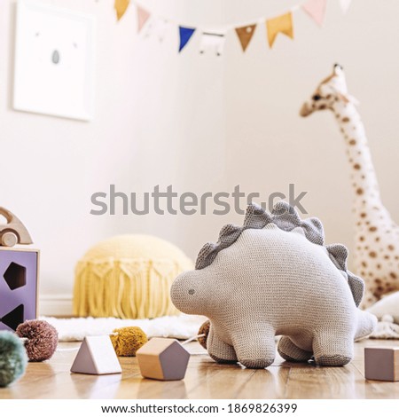 Stylish scandinavian interior of child room with mock up frame ,natural toys, hanging decoration, design furniture, plush animals, teddy bears and accessories. Interior design of kid room. Template.