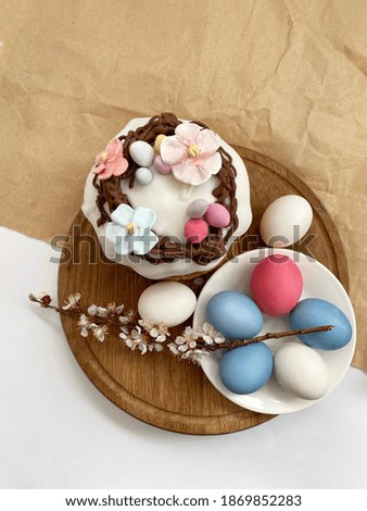 Colored easter eggs and easter cake background on wooden desk