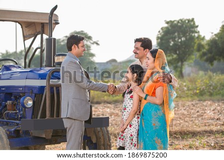 Financial advisor shaking hands with a farmer