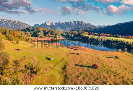 Aerial landscape photography. Amazing autumn view from flying drone of Wagenbruchsee lake with Westliche Karwendelspitze mountain range on background, Bavaria, Germany, Europe.
