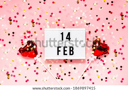 Saint Valentine's day  festive background. Bokeh lights and confetti February 14 . Top horizontal view copyspace. Royalty-Free Stock Photo #1869897415