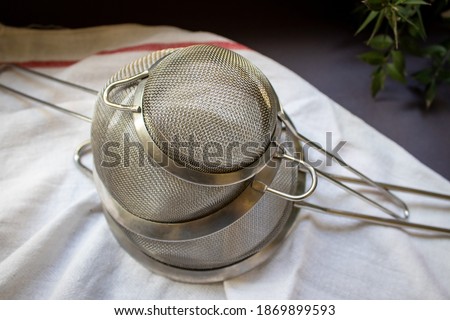 Metal strainer used in meal preparations. Top view and lined up. 