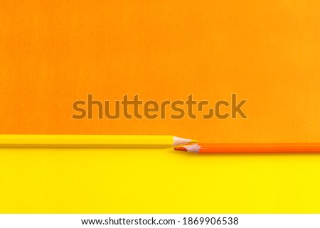 orange yellow background with pencils